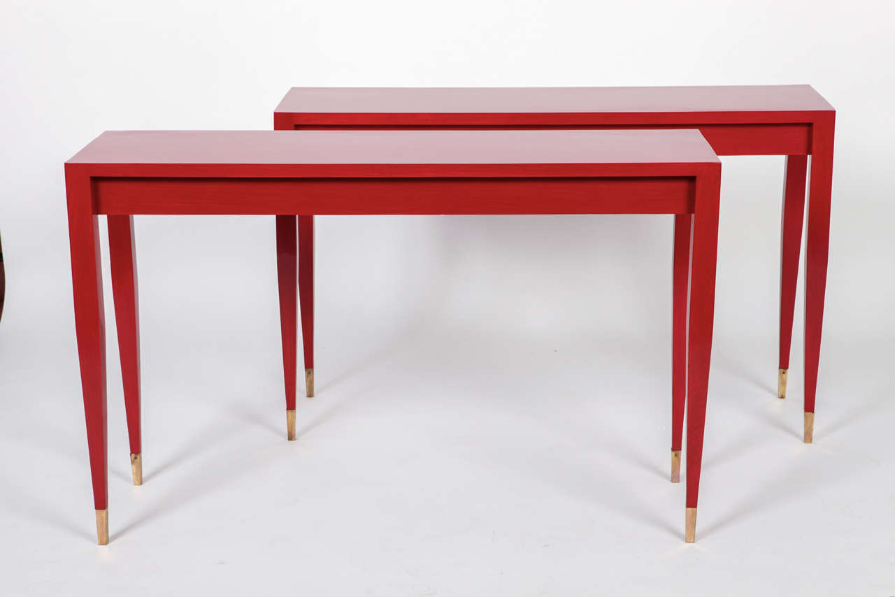 a Gio Ponti pair of red laquered  console from the original forniture of the Hotel Parco dei Principi in Roma and costumized in 2007 by Arch. Cristina Longo for a private residence in Italy; 
produced by Giordnao Chiesa
unique pieces; ash and brass