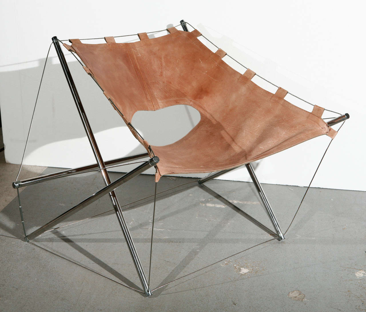 Leather lounge chair with tension wire by J.H. Varichon.