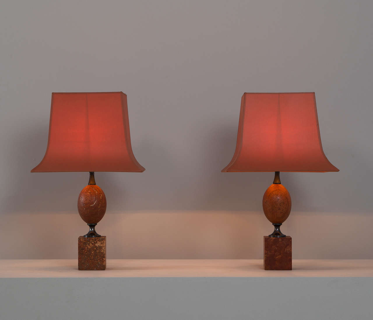Set of table lights, in travertine, for Maison Barbier, France, 1960s. 

Matching pair of elegant lights by Maison Barbier in rare red travertine.
Both the base, and the shade show interest shaped and well designed lines.
