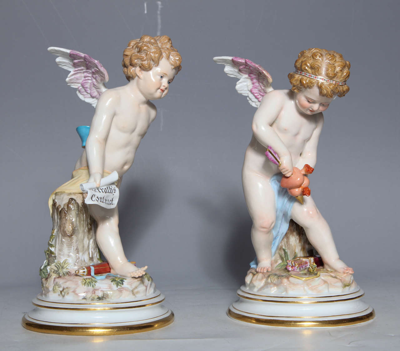 Pair of Meissen Porcelain large Devisenkinder Cupid figurines with superb quality painting and markings from the 1860s. The concept is taken from Otto van Veen’s Emblemes of Love published in Antwerp in 1608 with verses in Latin, English, and