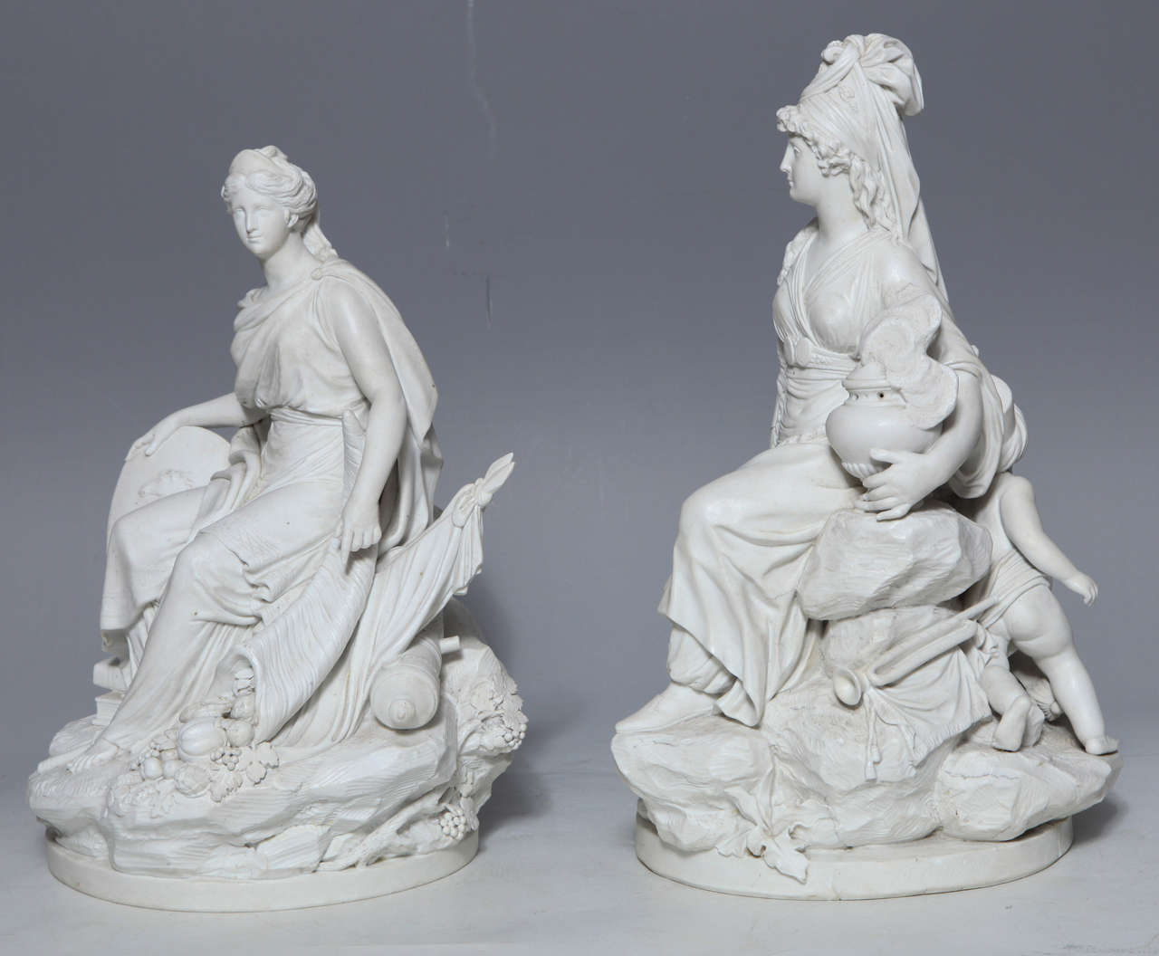 Pair of Sevres Biscuit porcelain allegorical figures of the continents, here Asia and Europe, emblematic of the Four Corners of the World. After the 1791 models by Simon-Louis Boizot. 

The figure on the left is the personification of Europe. She
