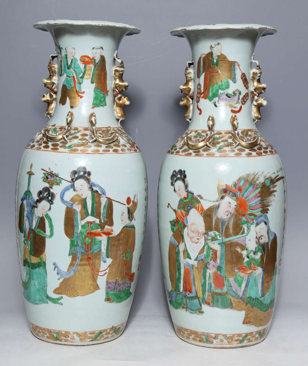 Pair of Chinese porcelain vases with painted figures and Chinese poems in gold. The gilt poem frames the two groups of figures who likely serve as a narrative complement to the calligraphy. These exquisitely detailed figures encircle the vase their