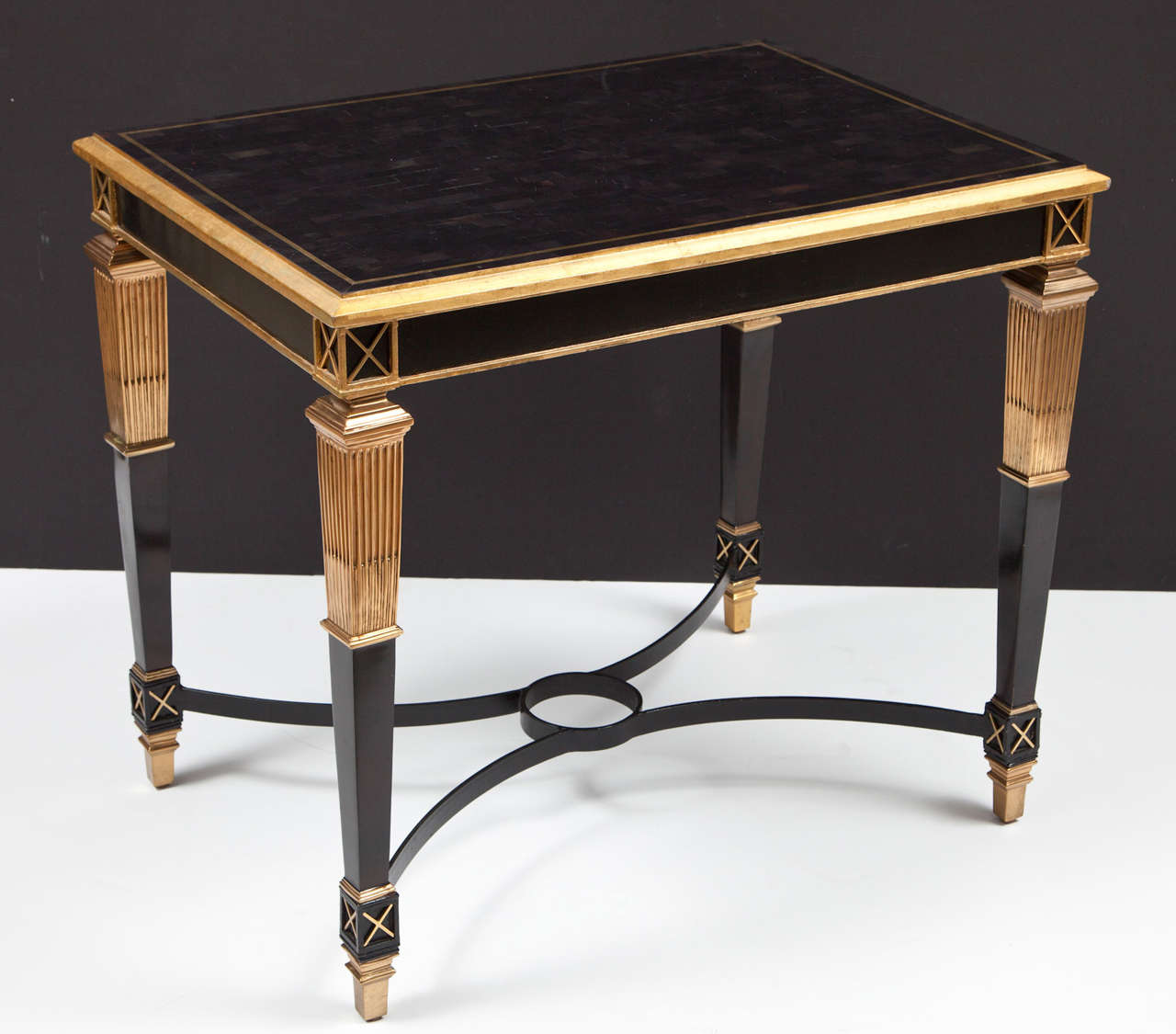 A sleek table in a high gloss finish with gilt metal accents. Perfect for a small entry, a side table or a bar.