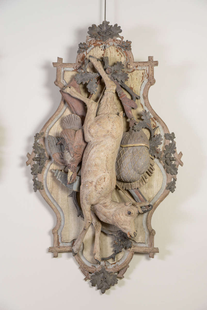 Pair of carved wood polychrome hunting trophies with a deer, chamois, grouse, powder flasks, shotgun and game bag decor on convoluted panels with branches decor, oak leaves and acorns decor.
Louis XVI Style.