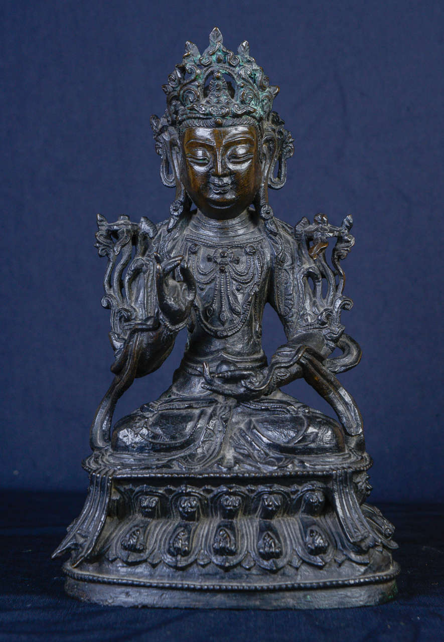 A bronze figure of Buddha, seated on a lotus base. China Ming dynasty, 17th century.