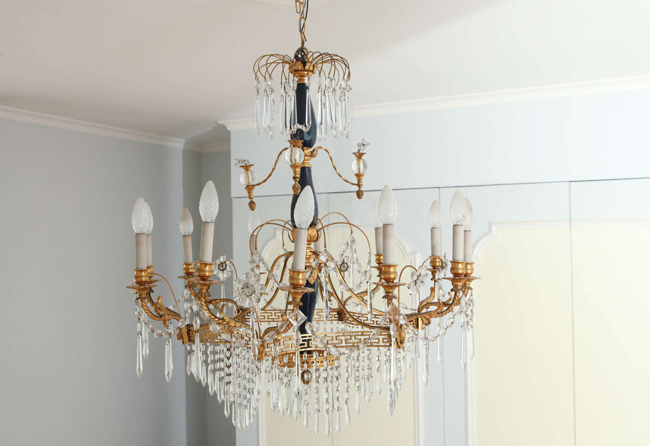 A 19th century neoclassical style crystal and gilt bronze, twelve-light chandelier centered with opal blue glass.