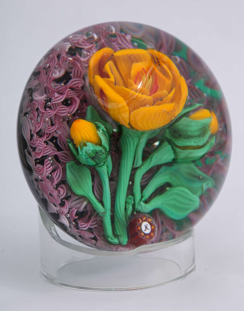 A rare Jim Kontes paperweight with a dimensional yellow flower and two yellow buds on a ground of pink lattice strips, signed with a 