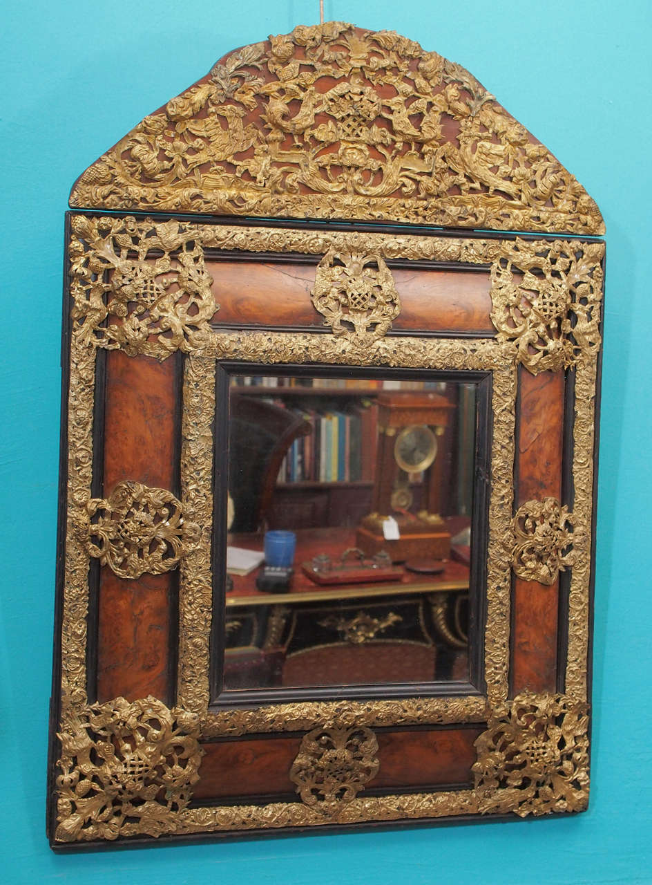 Exceptional early 18th century French Louis XIV period mirror with burl walnut frame surmounted by exuberant bronze overlays, circa 1710.