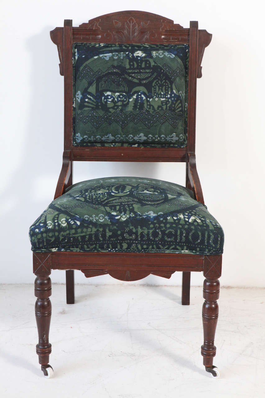 Vintage chair on casters newly upholstered in African textile.