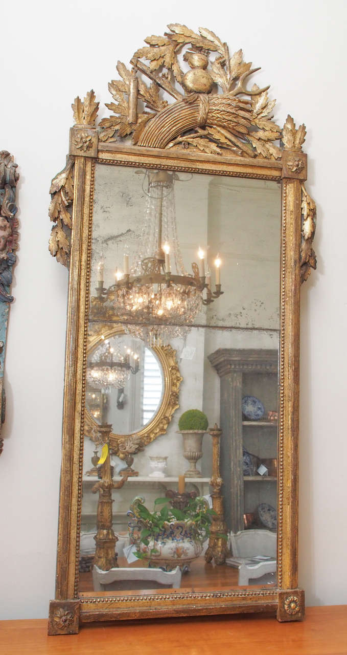 18th century mirror with a two split glass/carved and gilded wood in a foliage motif.