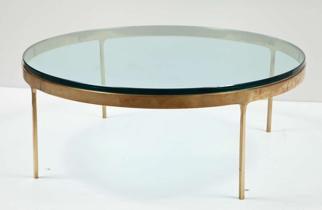 Fantastic brass framed coffee table with iconic stiletto legs with a glass top. Designed by Nicos Zographos.