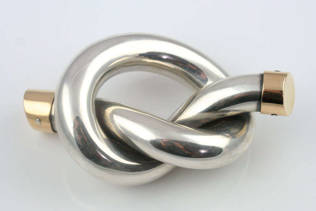 A lovely Gucci sterling silver knot paperweight with 18k gold end caps. Stamped on the underside with the Gucci and sterling marks (see Image 8) as well as 18k mark (not shown).  See the matching letter opener and magnifier in another listing.