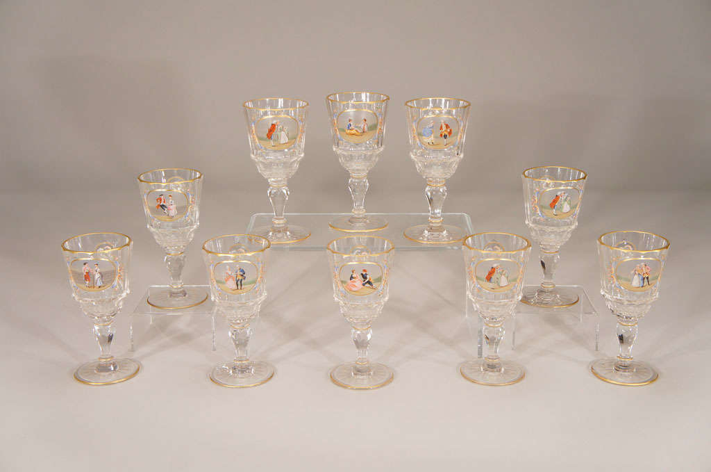 This is a beautifully executed set of 10 hand blown crystal water goblets, unsigned but surely made by Lobmeyr. The unusual shape and size makes them extremely practical, while the hand painted reserves of figures in period dress, exemplify the