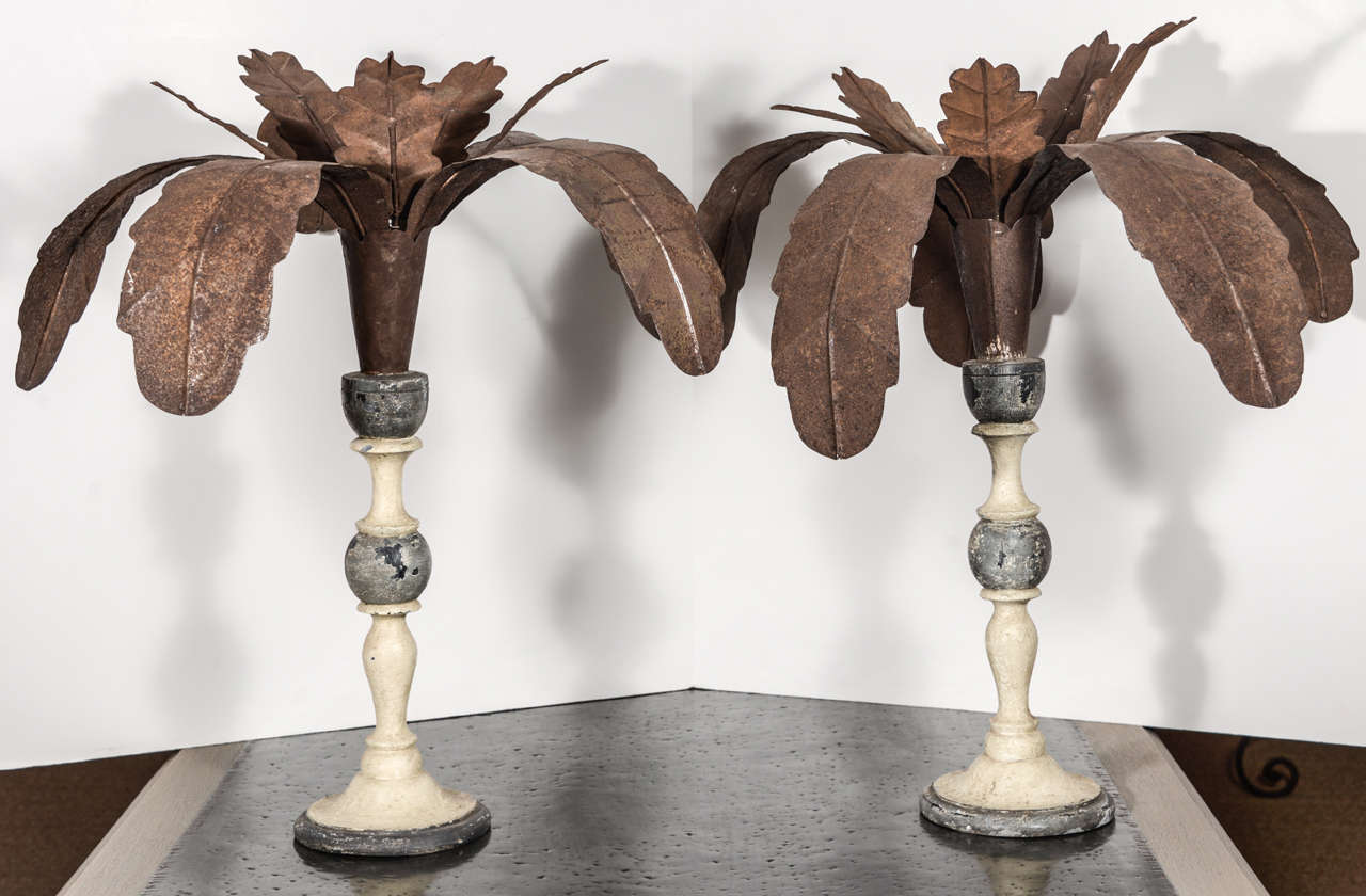 Vintage pair of Italian tole palms atop painted turned wood pedestal bases.