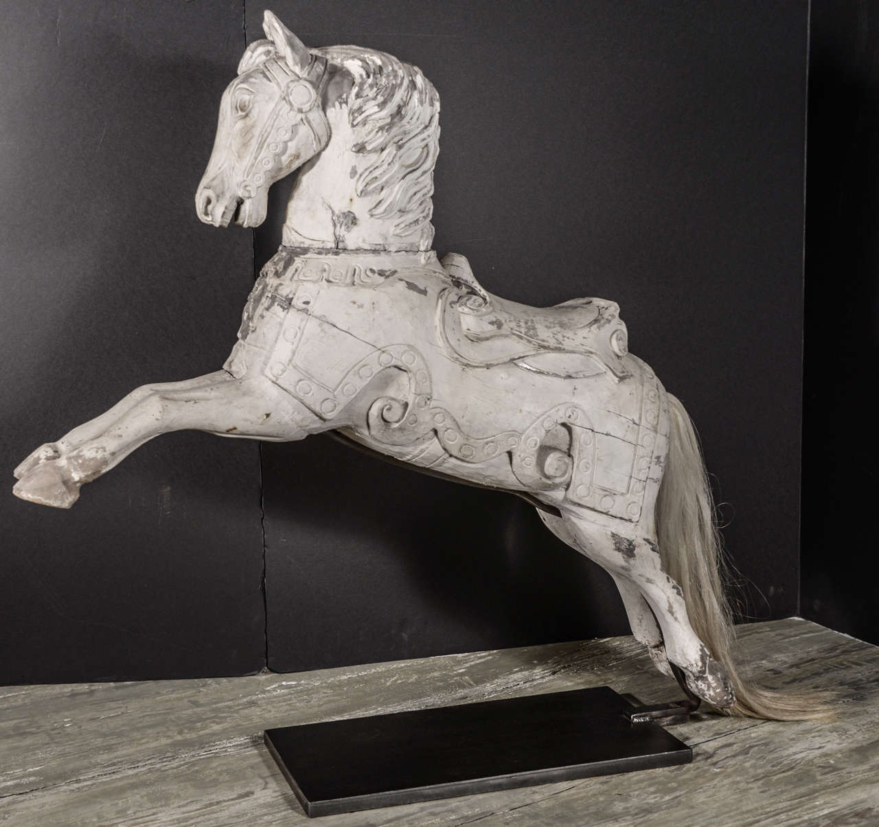 Antique white painted ‘cheval en bois,’ circa 1860-1880, mounted on custom iron stand with horse hair tail.