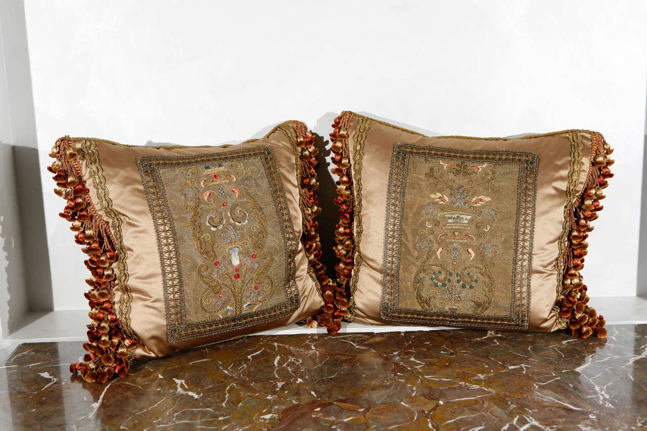 19th c. French Fragment Pillows with Silk Velvet backing. The antique French metal thread tapestry fragments have been meticulously restored and masterfully sewn onto silk fabric to create these beautiful pillows. Decorative tassel silk trim has