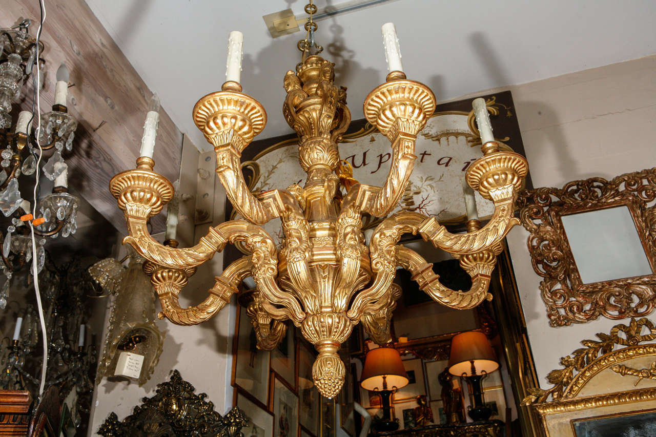 A reproduction of French style eight-arm Chandelier with giltwood. The price below is for a single chandelier.