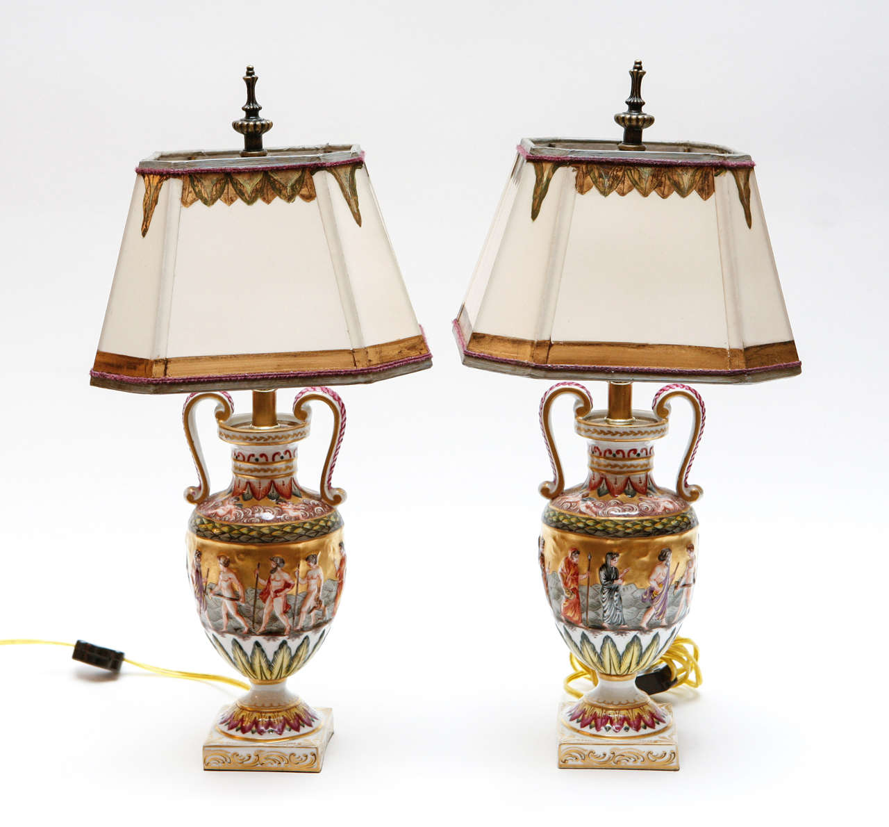Pair of 19th c. Italian Capodimonte Porcelain Urns that have been converted to lamps.  They are gilded and painted. The Shades are included and are Hand Made of Parchment Paper. They are Hand Gilded and Decorated. The lamps have been newly wired.The