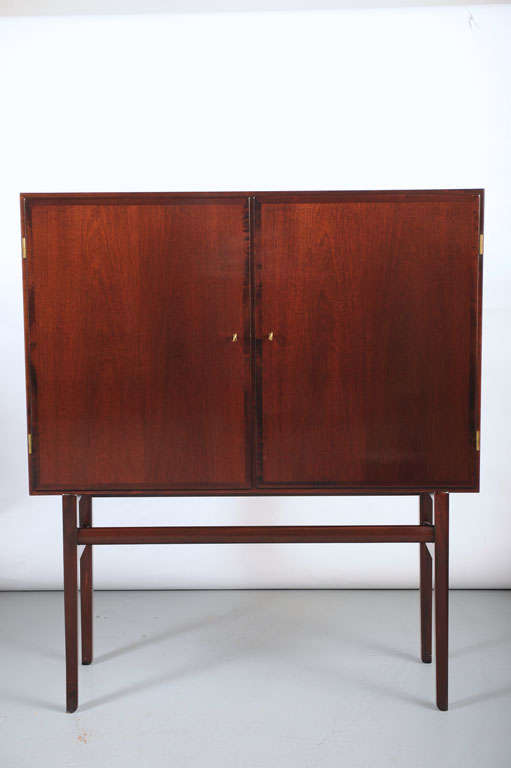Ole Wanscher, mahogany cabinet with Two doors in front enclosing shelves and one drawer, key included. Produced by P. Jeppesen.