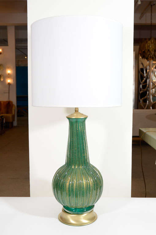 Exceptional pair of Emerald Green Murano glass lamps with gold inclusions and gored details on satin brass base.