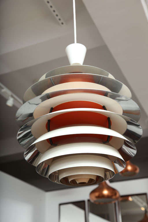 Large pendant lamp with 10 shades, and orange and chrome interior.