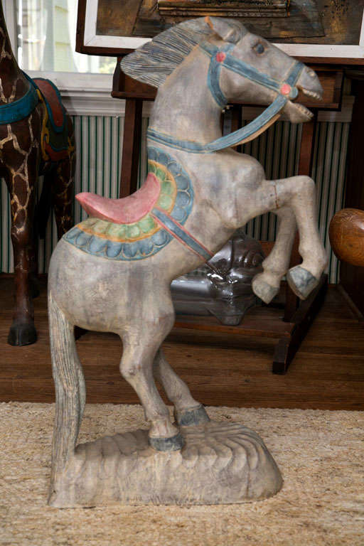 CARVED WOOD STATUE OF STANDING HORSE DECORATED AS A CARNIVAL
TYPE FIXTURE IN MINITURE- PAINTED GREY BACKGROUND