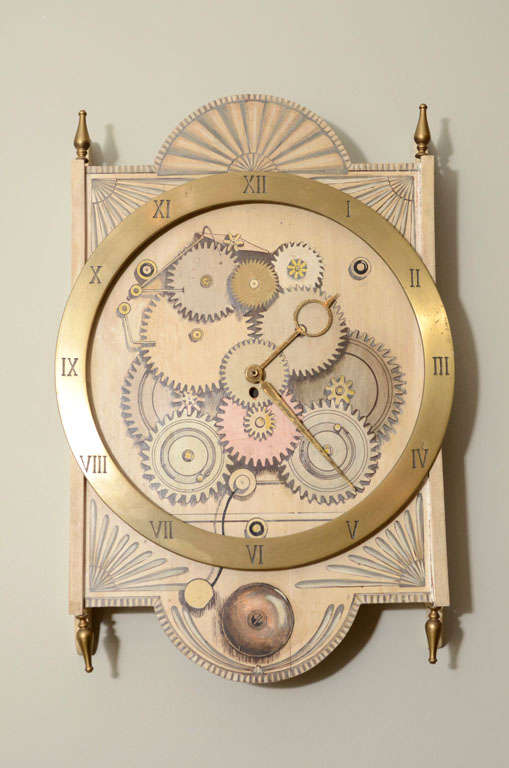 Fornasetti-style wall clock in silk-screened wood with a design of gears, ornamented with a huge brass chapter ring with roman numerals. Battery movement. Metal Palladio tag on reverse.