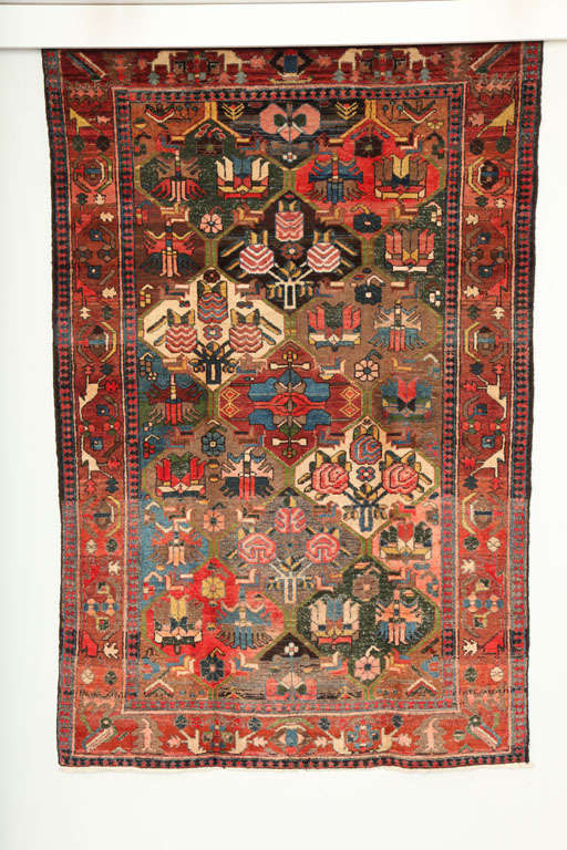 This garden design Bakhtiari from the Ferehan village consists of a cotton warp and handspun wool weft and pile. The bright reds, blues, greens and pinks in this carpet were all created using organic vegetable dyes, and the asymmetrical quality of