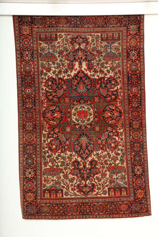 This Persian Fereghan rug consists of a cotton warp and weft and handspun wool pile. Its vivid yet earthy colors are derived from organic vegetable dyes, the reds, greens, blues and cream tones working together to create a unique medallion design