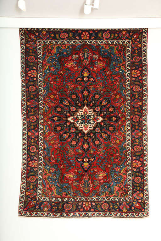 This 1920 Bibibaft Bakhtiari is an improvisational piece of exceptionally fine quality. It consists of a cotton warp, handspun wool weft and hand-knotted handspun wool pile, and its rich blues, reds, pinks and greens were all created using natural