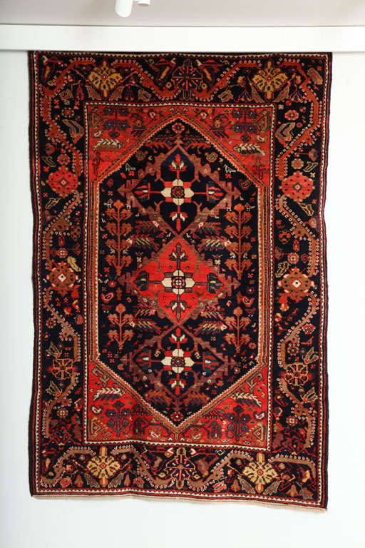 This 1900-1910 Persian Meeshan Malayer rug consists of a cotton thread warp, handspun wool weft and hand-knotted handspun wool pile. Its rich reds, coppers, midnight blues and golds were all created using organic vegetable dyes. Woven in the village
