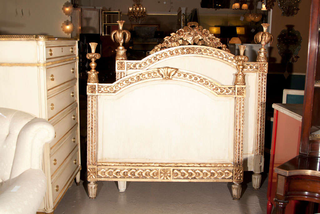A fabulous set of Louis XVI style headboard and footboard, circa 1940s Jansen, painted white in the middle-part with gold-leaf decoration. Interior Box-spring Dimensions are 48 by 72