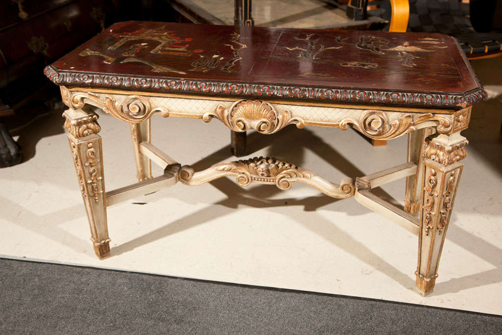 French Louis XVI style coffee table, circa 1940s, dark red painted rectangular top with raised chinioserie scene, supported by an elegantly carved base of four squared tapering legs. A fine quality piece and an important style of Jansen Furniture.