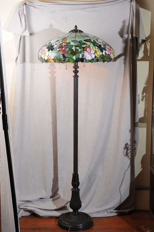 It's hard to find period leaded glass lamps as floor models.  Note the very colorful flowers and beautiful bronze base.  A great addition to any period setting.