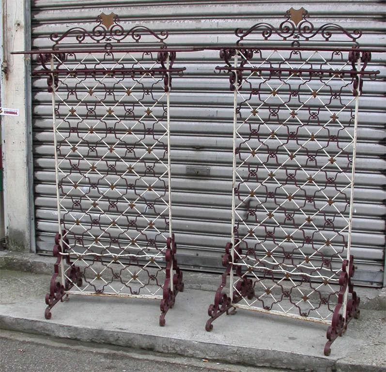 Two end of 19th-early 20th century oversize coat stands in wrought iron, with structure entirely mounted with screws, no soldering; brass hooks. Very high quyality workmanship.