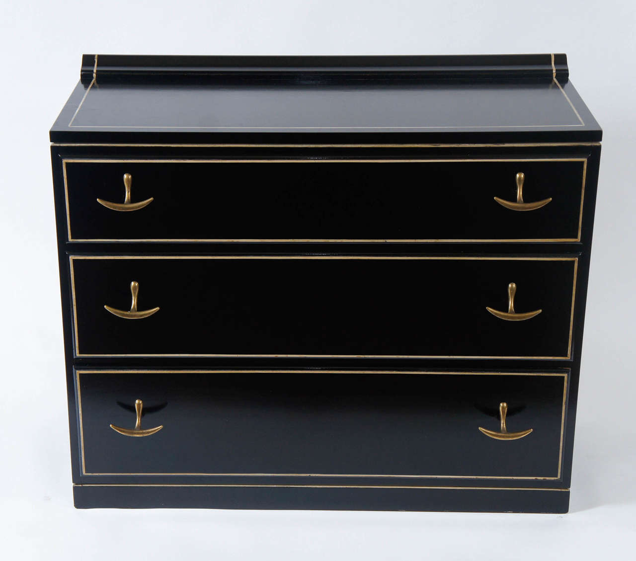 Elegant vintage black lacquered three drawer chest by Kroehler having dramatic brass splayed anchor form pulls and original ivory piping bordering drawer fronts and top.