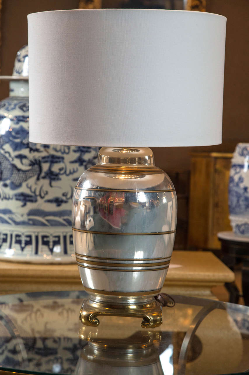 A French vintage mercury glass lamp with gilt banding.