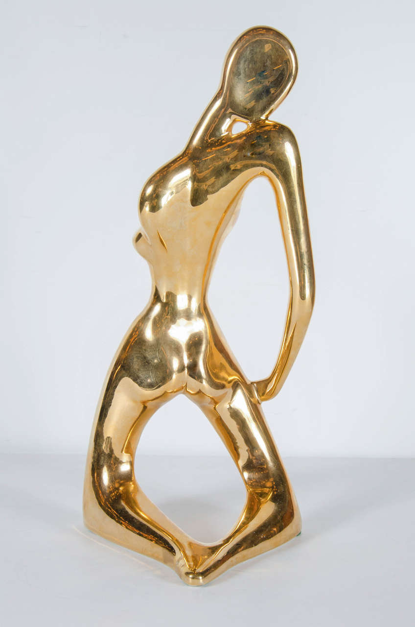 This gold-plated ceramic sculpture features a kneeling figurative sculpture with stylized Cubist form. It bears the signature Jaru on the bottom.