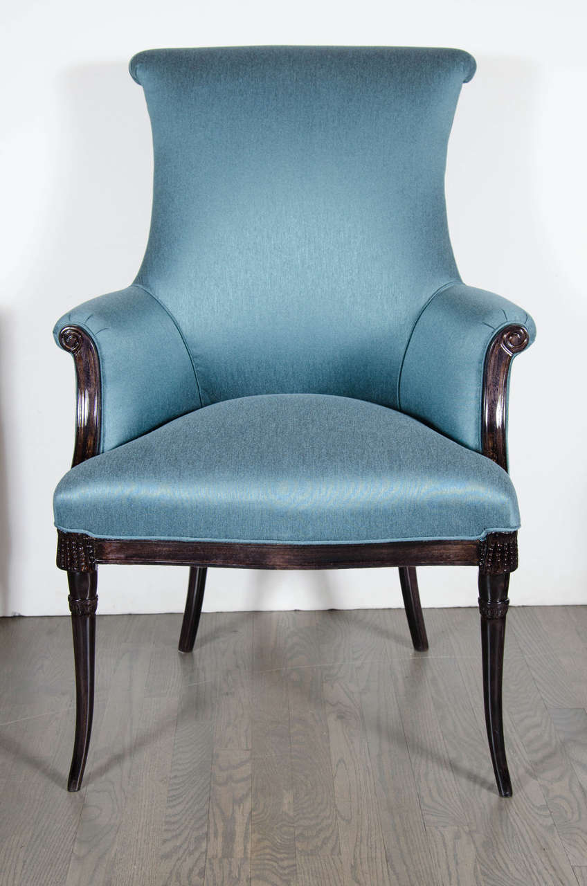 These stunning chairs are made of hand carved ebonized walnut and have been newly upholstered in a gorgeous robin's egg sharkskin. They feature a scroll back design, tapered legs, and scrolled arms as well. These are in mint restored condition.