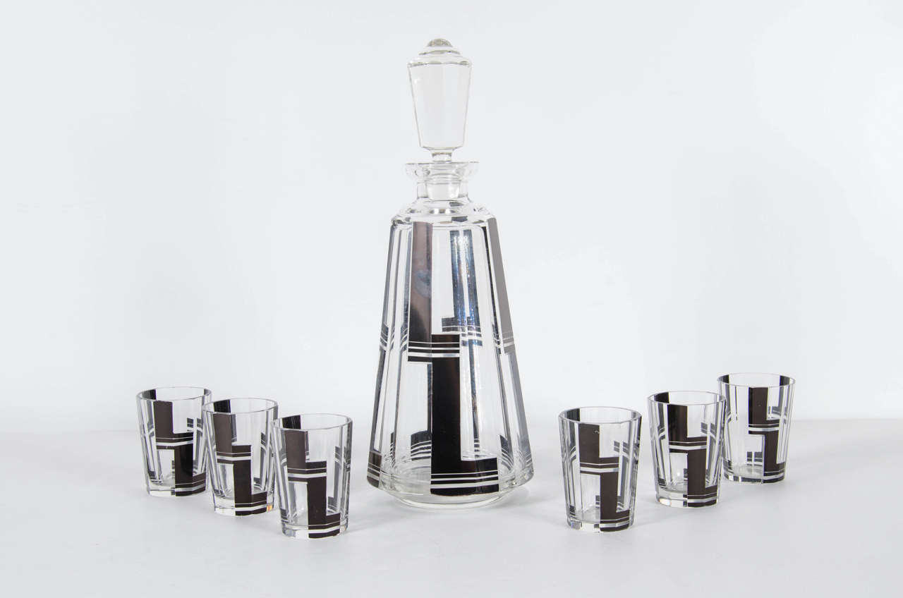 This very luxurious decanter set features faceted conical design with stylized black etched Art Deco geometric detailing. This set is in mint condition and would be stunning on any bar or cabinet.