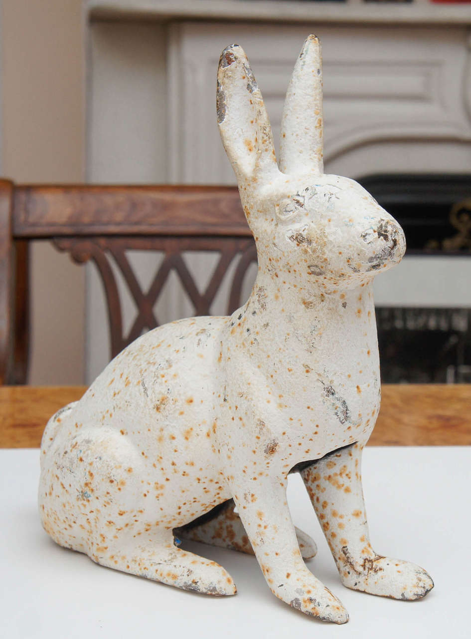 White painted cast iron rabbit. Garden ornament or door stop. Probably French.