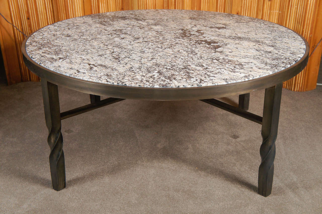Circular marble top cocktail table on patinated metal base.