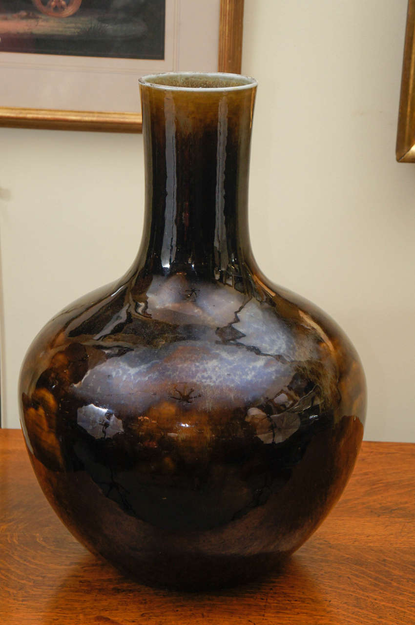 Large bottle form Japanese vase with an umber glaze.