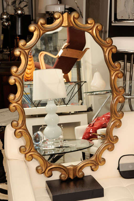 A very decorative gold mirror from the 1950s.
The mirror has been refinished since the pictures were taken.