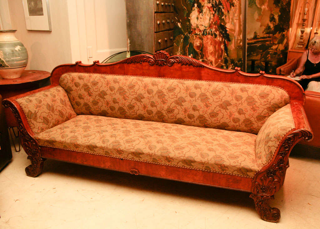 Late Biedermeier sofa from Denmark in birchwood with carved arm supports and crest rail, scrolled arms and legs, mid-19th century.