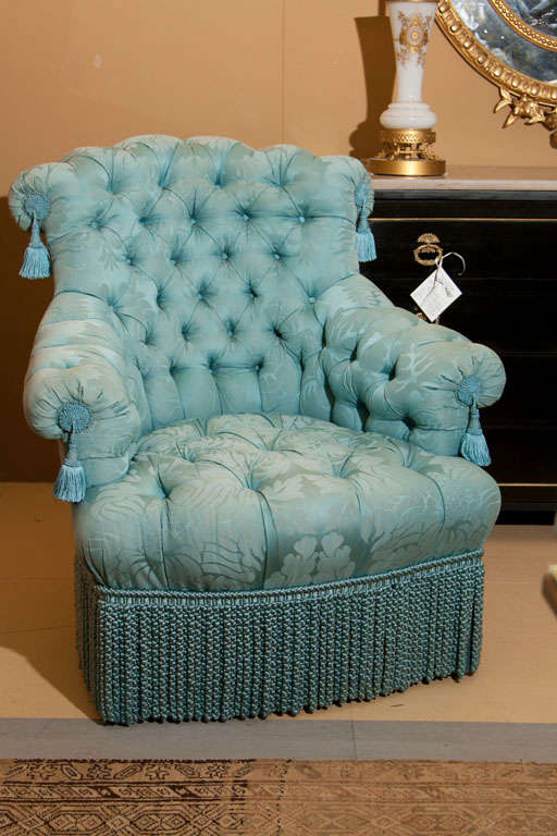 Pair of tufted armchairs upholstered in aqua blue silk.