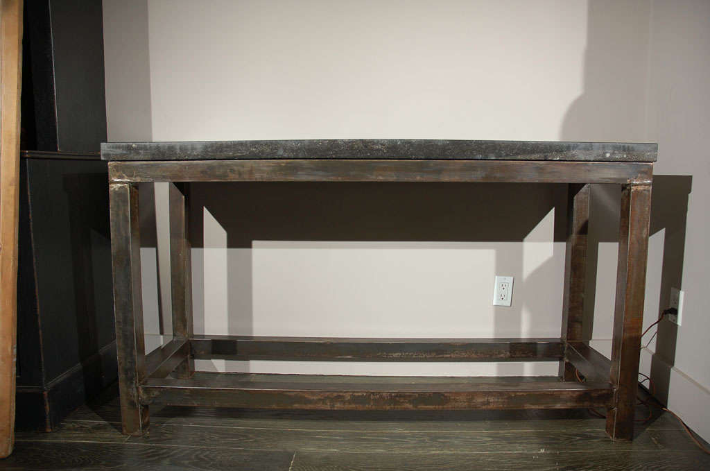 This fabulous console has a stone top upon a iron base with square legs joined by a stretcher