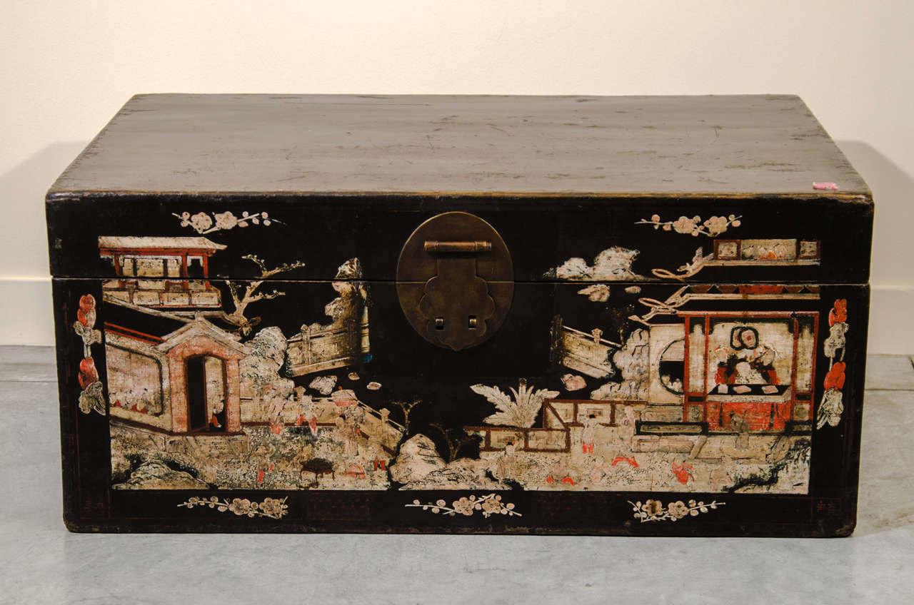 A beautifully painted lacquer trunk with chinoiserie on three sides and a striking red interior.  From Shanxi Province, c. 1900.  
CST327