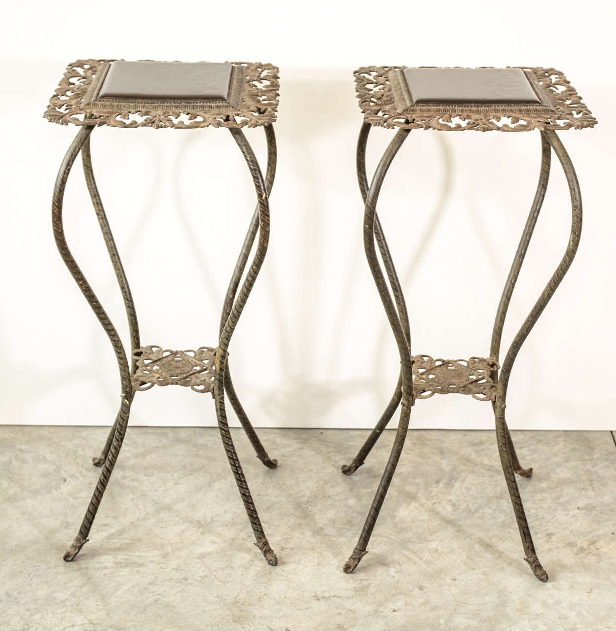 A pair of antique iron flower stands with lacquered tops. From Tianjin, China, circa 1900.  Graceful and unusual.
T509