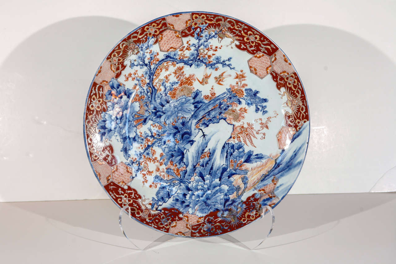 Large, detailed Imari charger featuring a peacock, cherry blossoms and a border of fish-scale designs.